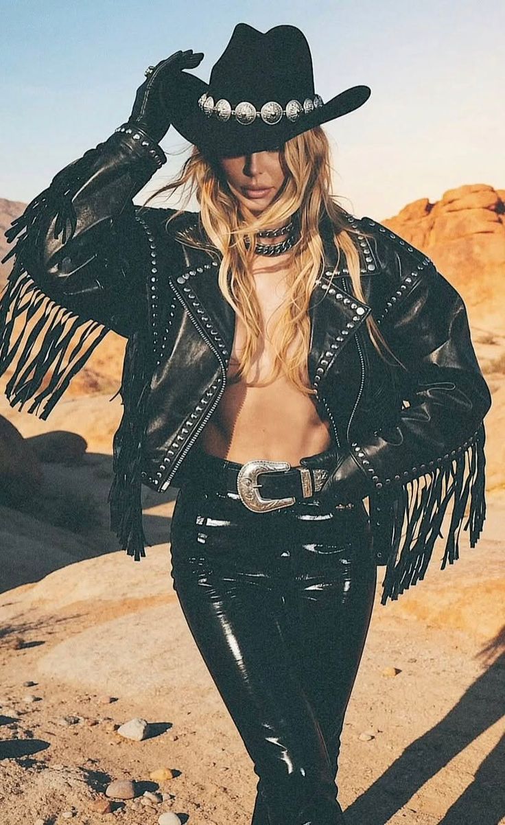 Woman in a cowboy hat and fringed leather jacket in a desert setting