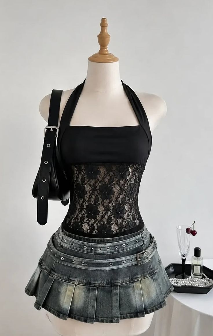 Mannequin wearing a black lace halter top and a denim pleated skirt