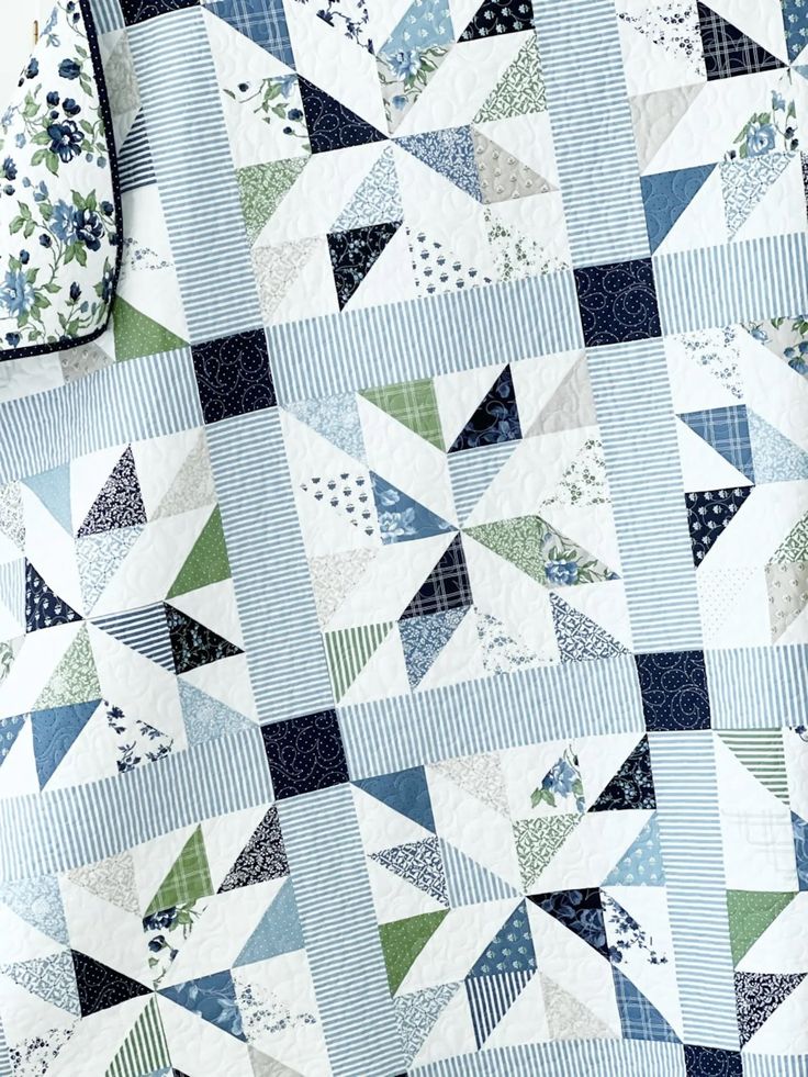 Close up of a quilted fabric with blue and green patchwork patterns