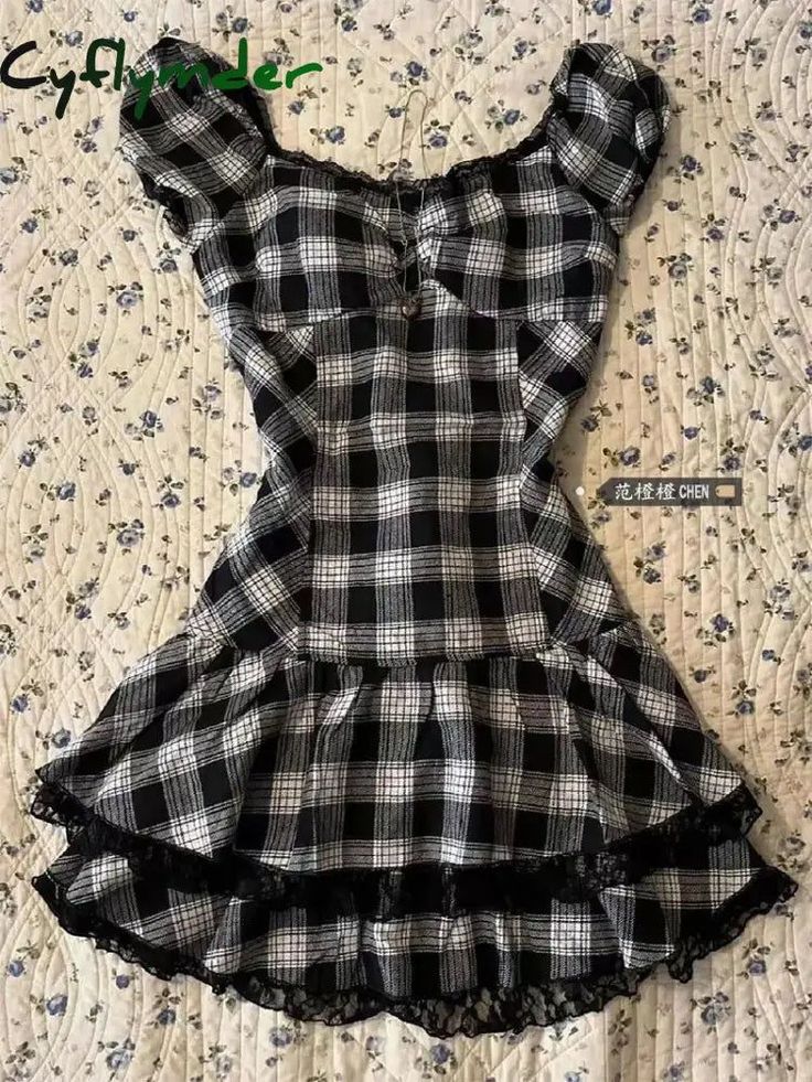 Black and white plaid dress with lace trim and ruffle hem on a floral quilted background