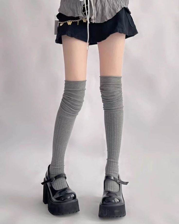Person wearing a mini skirt, thigh high socks, and platform mary jane shoes