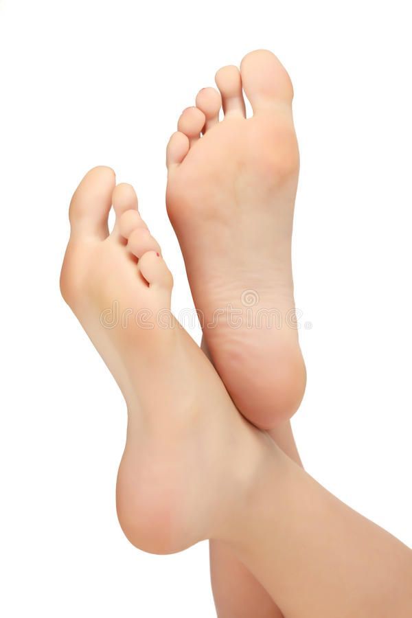 Two bare feet with soles visible, crossed against a white background