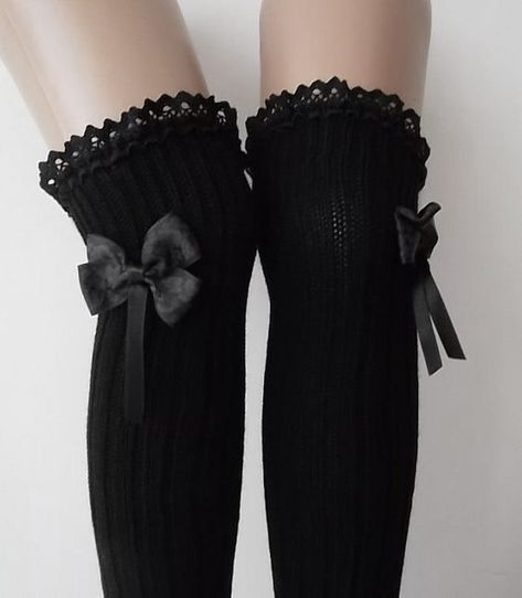Pair of black thigh-high socks with lace trim and bows