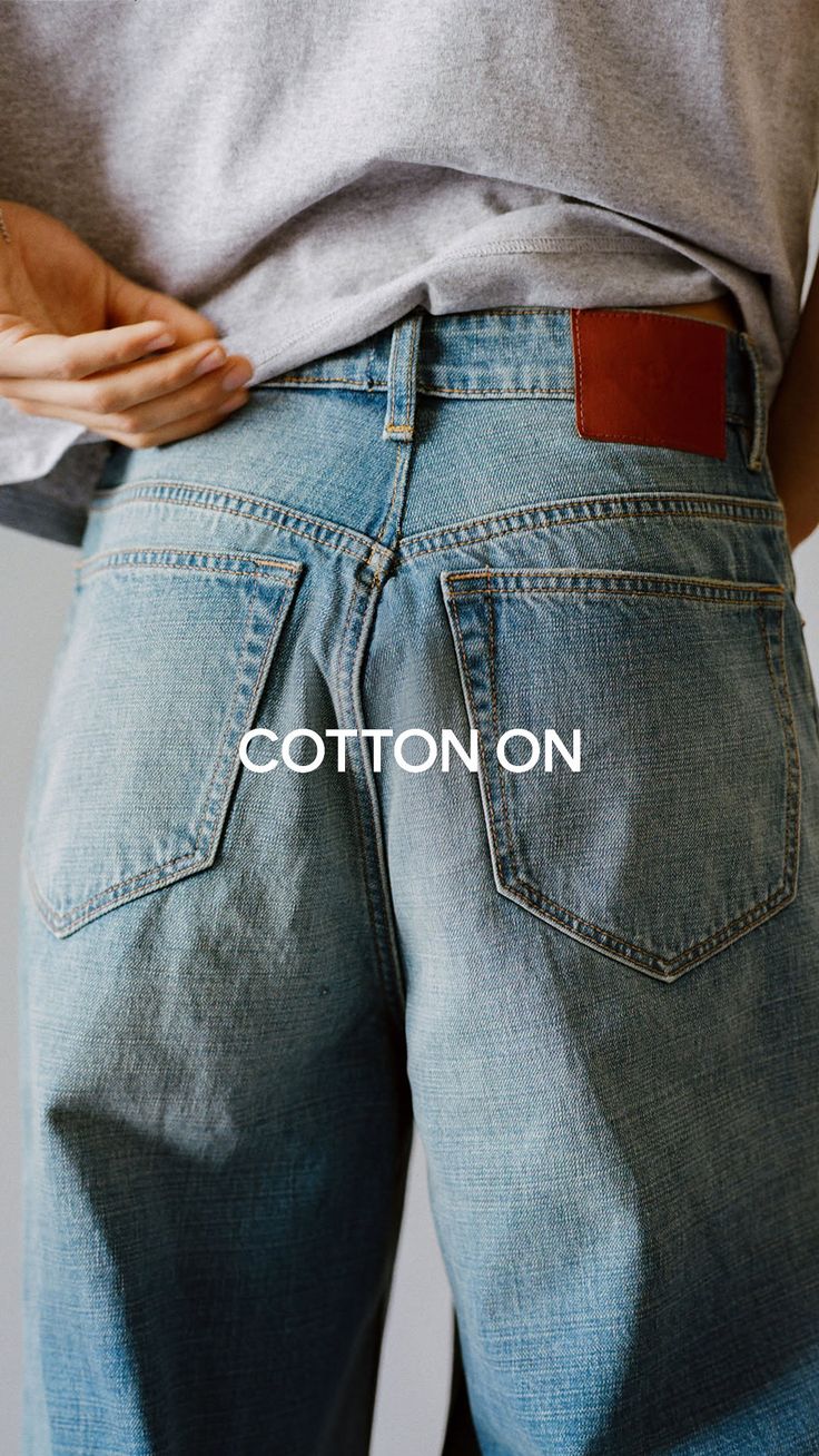Person in blue jeans and a grey t-shirt from the back