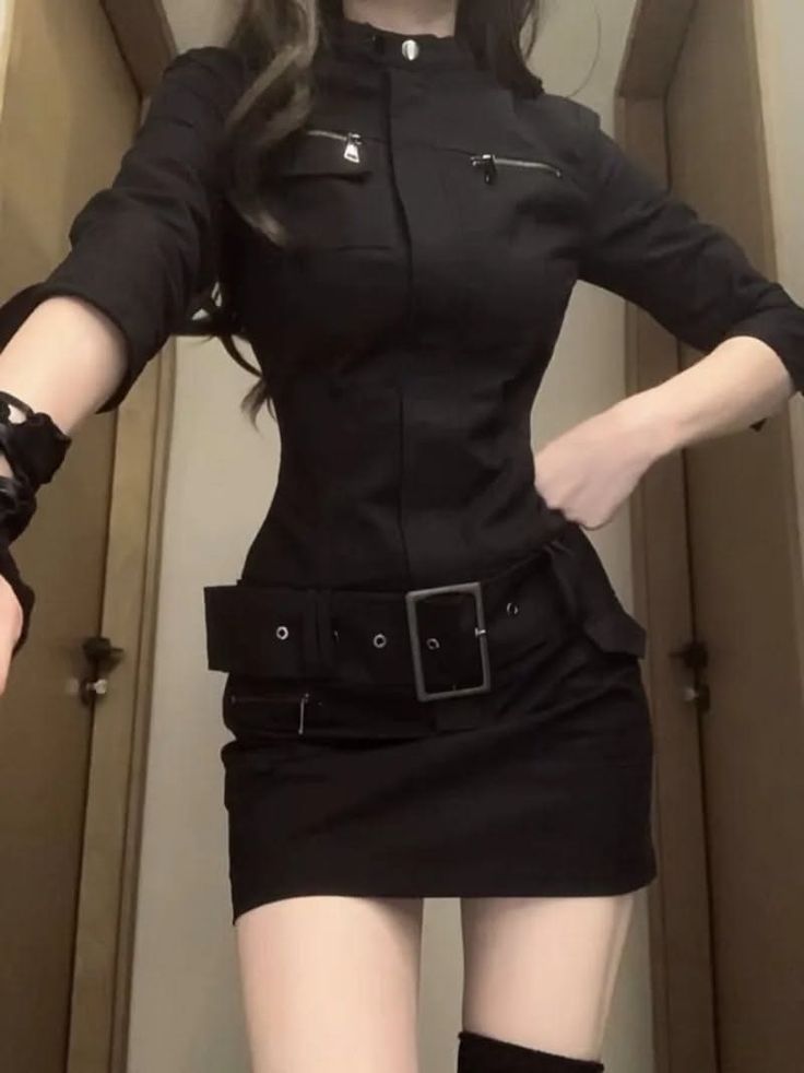 Woman in a black dress with a wide belt and thigh high boots