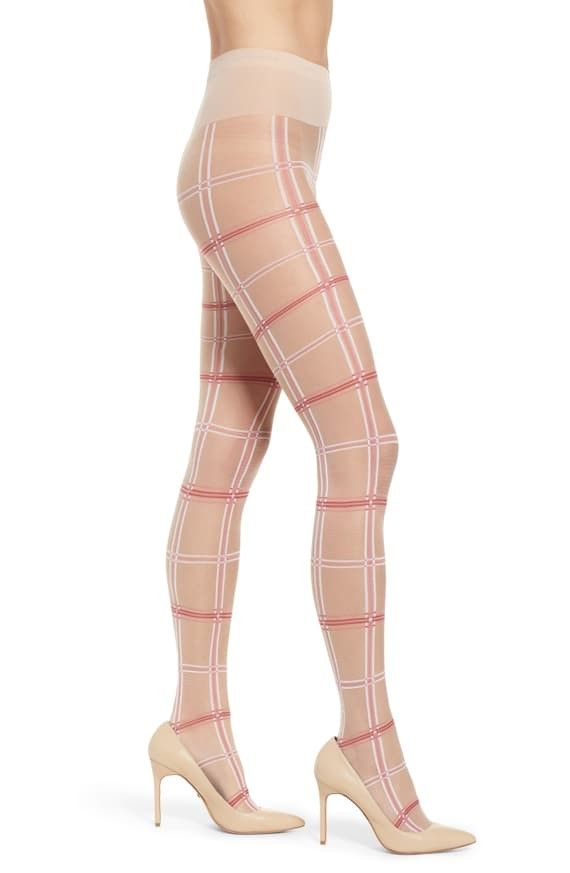 Woman wearing plaid tights and high heels on a white background