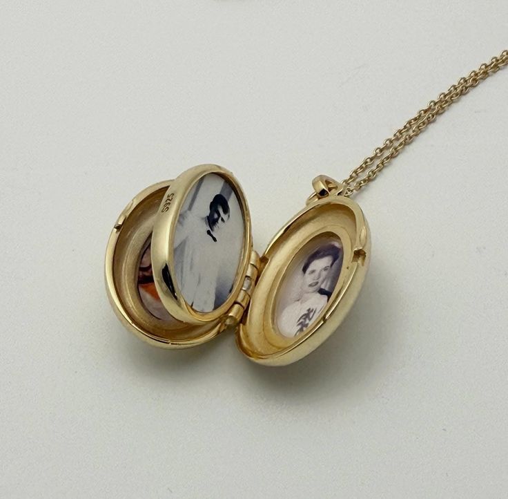 Open gold locket with two vintage black and white photos inside