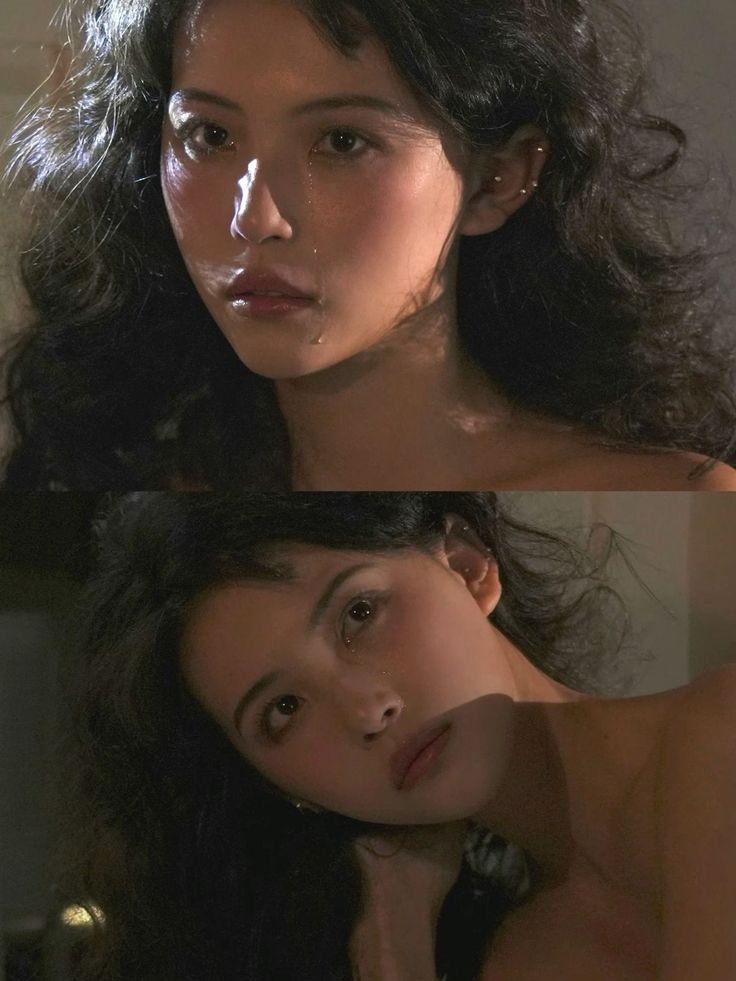 Woman with long wavy hair and tears on her face, bare shoulders
