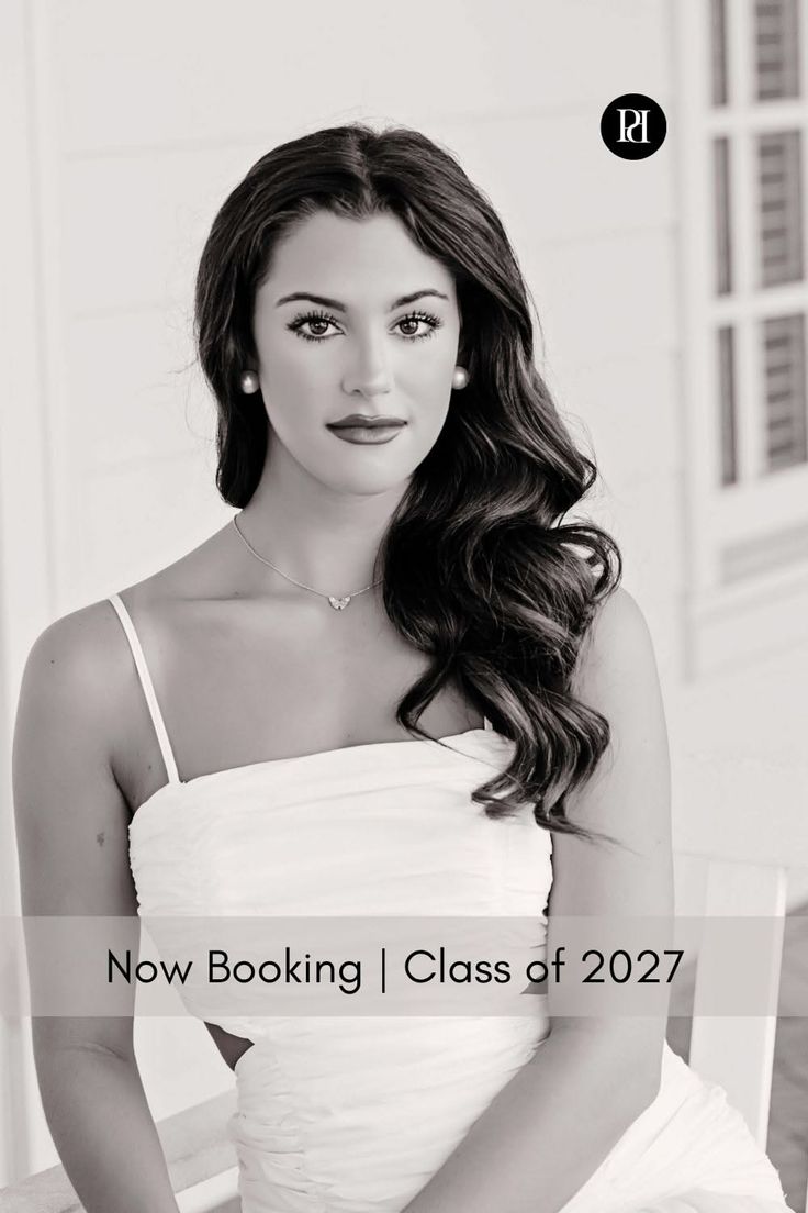 Woman with long wavy hair wearing a white dress and pearl earrings