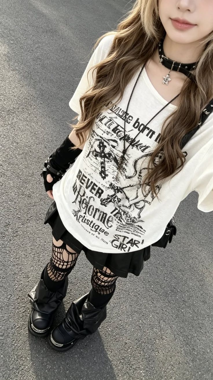 Person in a graphic t-shirt, black skirt, and fishnet stockings outdoors