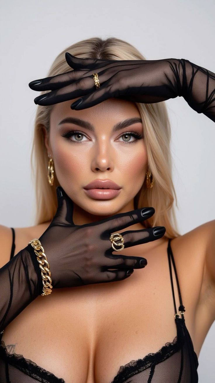 Blonde woman in black sheer gloves and lingerie with gold jewelry