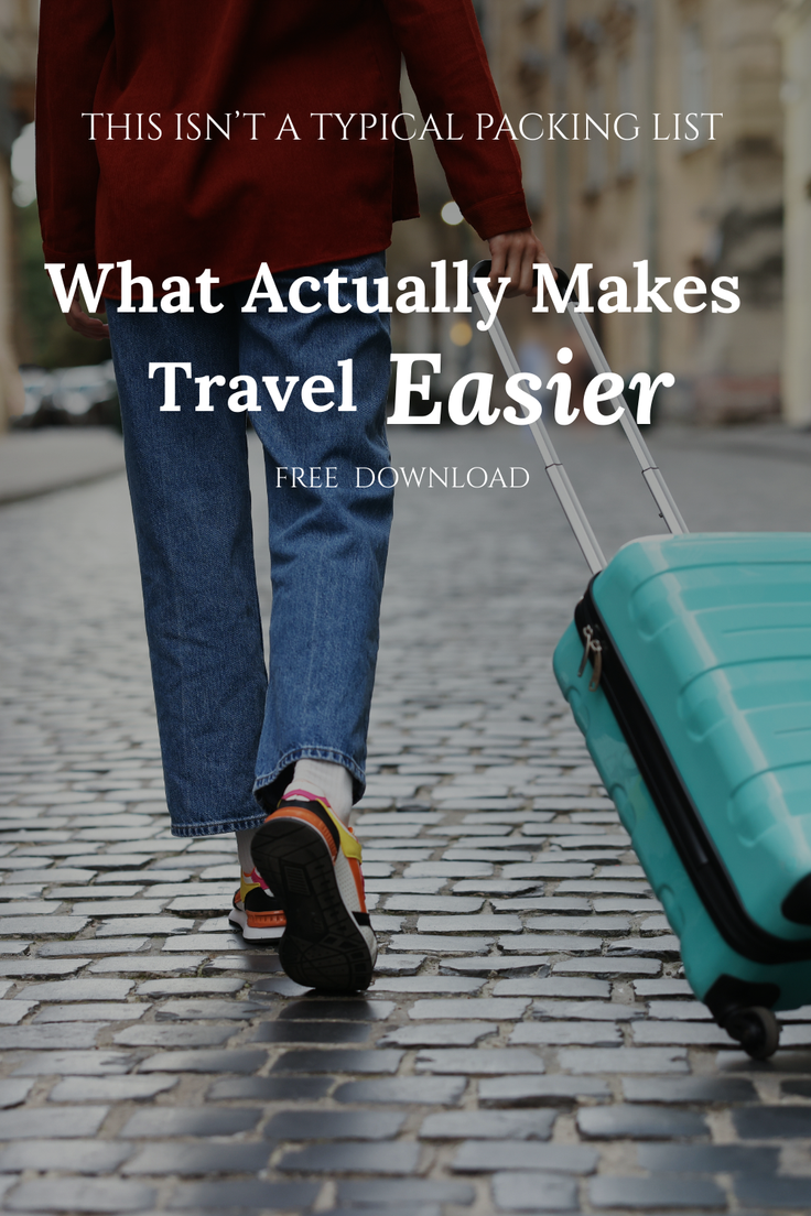 Person walking on a cobblestone street pulling a turquoise travel suitcase