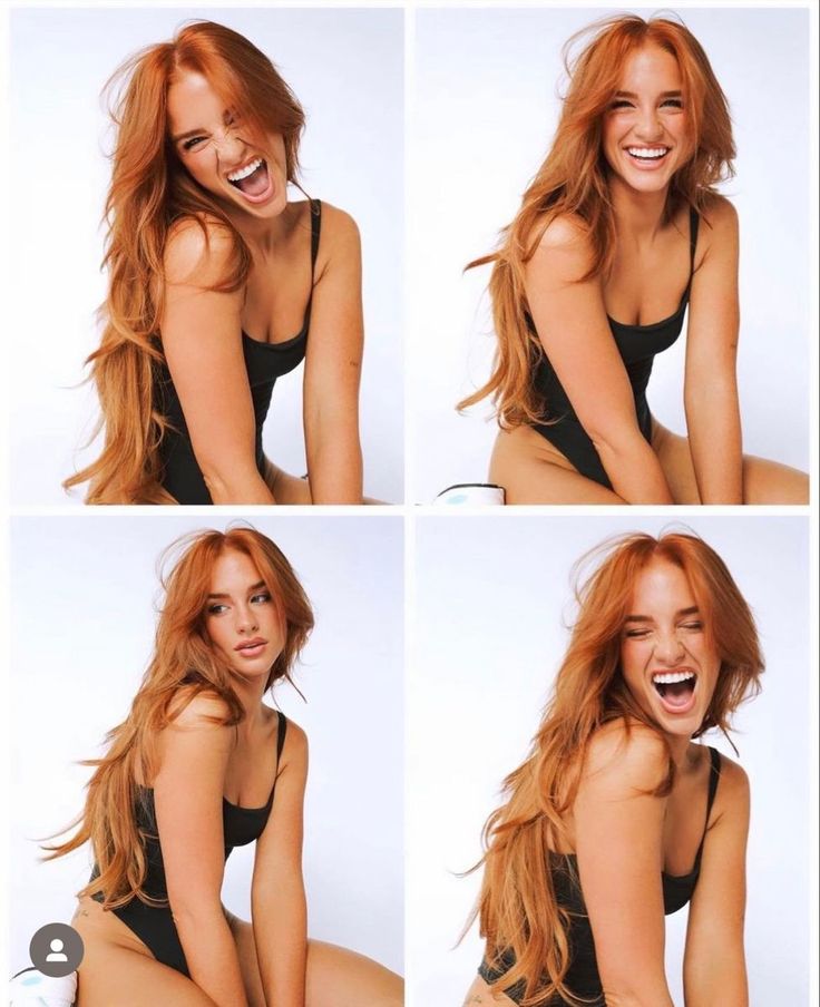 Woman with long red hair in a black swimsuit posing in a studio