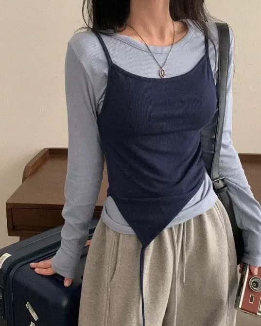 Person in a long sleeve shirt and spaghetti strap top with sweatpants
