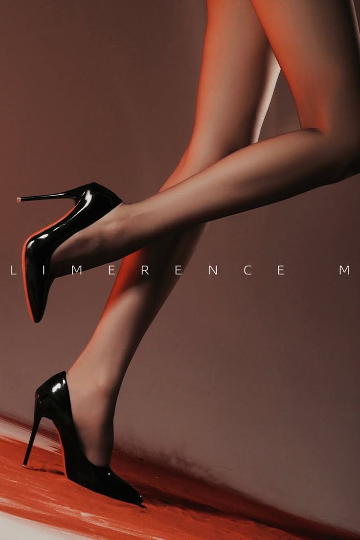 Woman's legs in black high heels with dramatic lighting and red accent