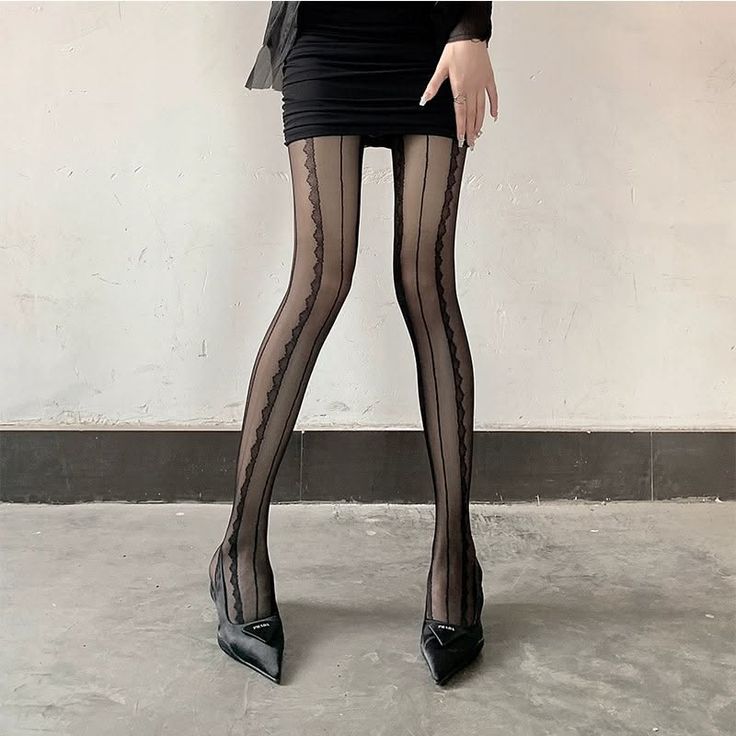 Person in a black mini skirt and sheer stockings with high heels