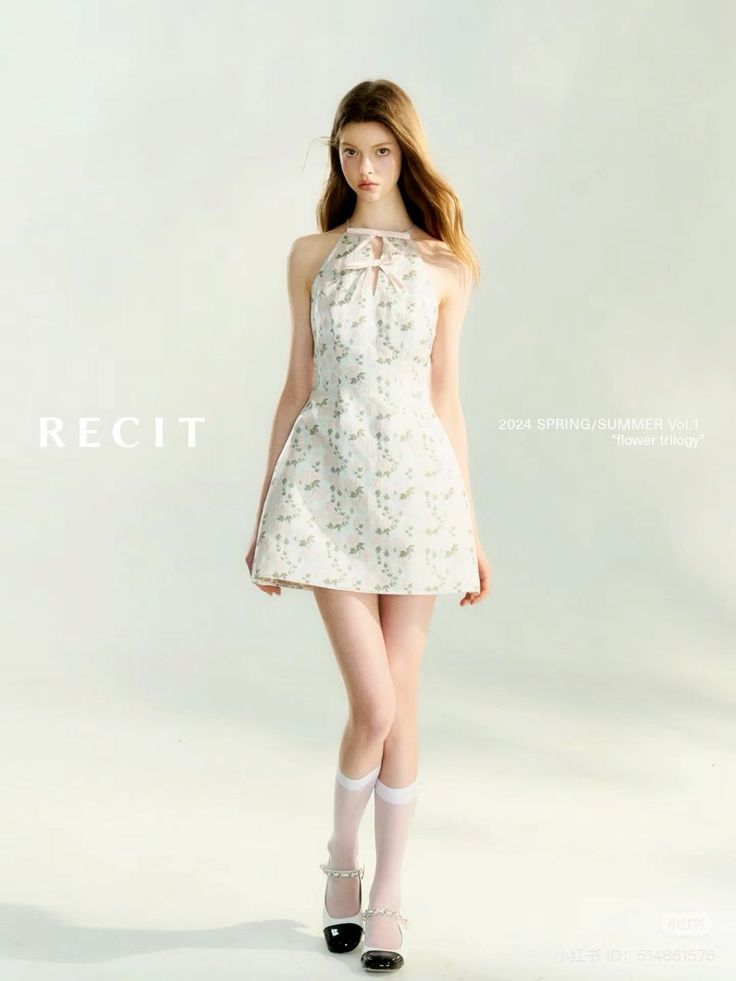 Woman in a white floral halter dress and white socks posing in a studio