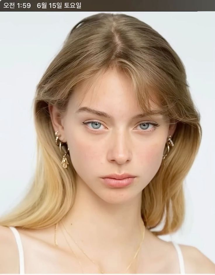 Young woman with blonde hair and blue eyes wearing jewelry