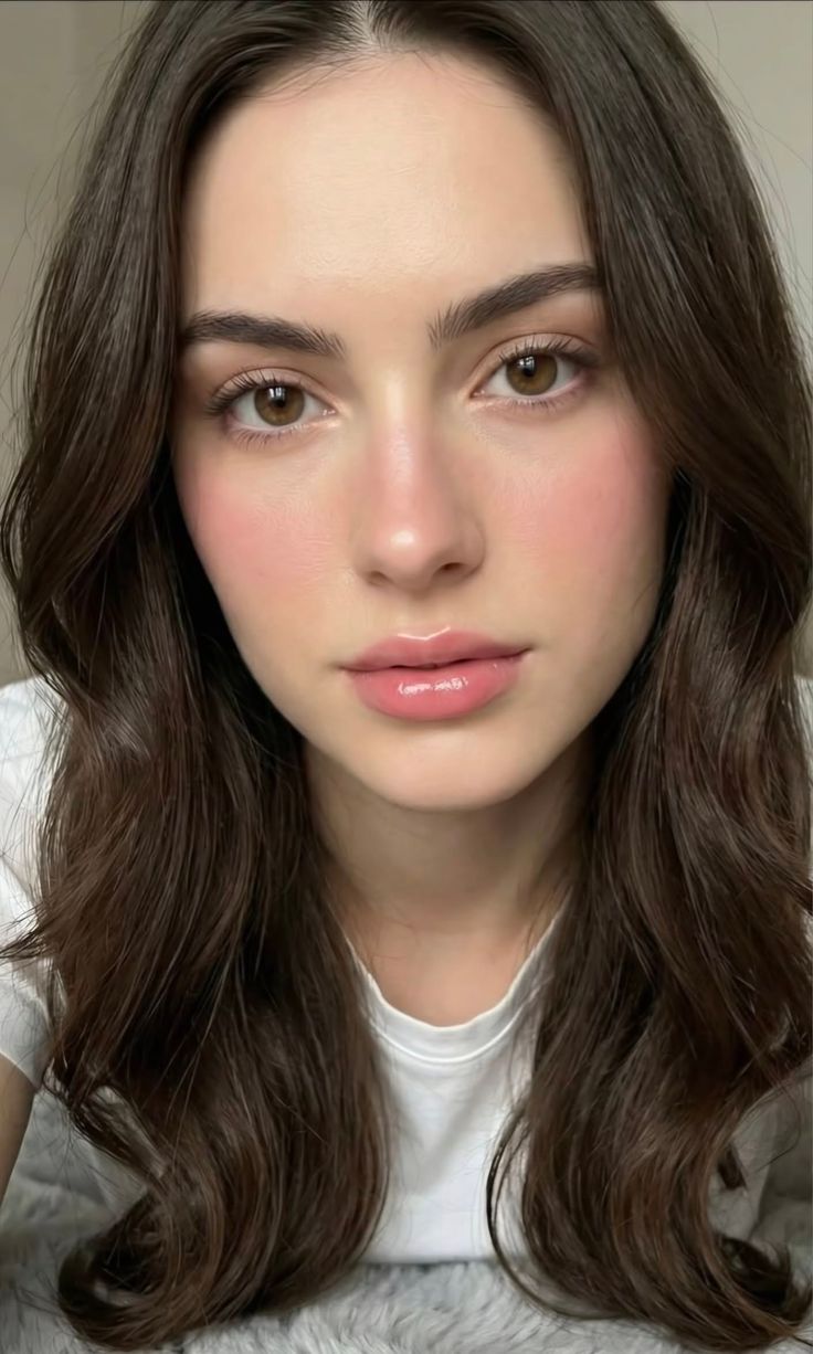 Close up portrait of a woman with long brown hair and pink lips