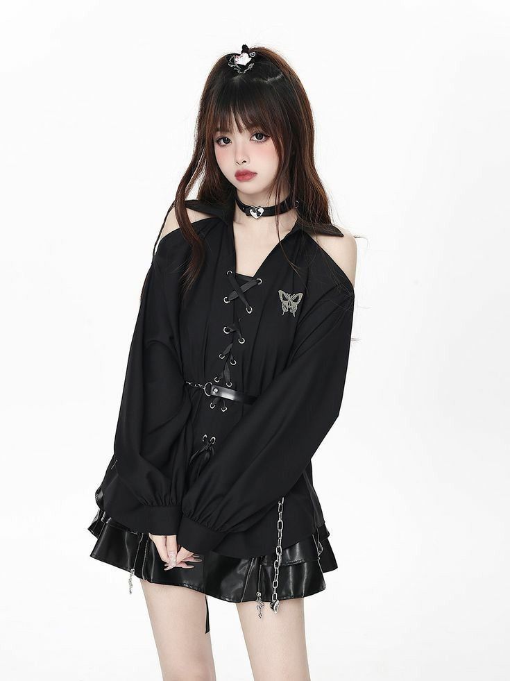 Woman with long hair wearing a black top and mini skirt with a choker