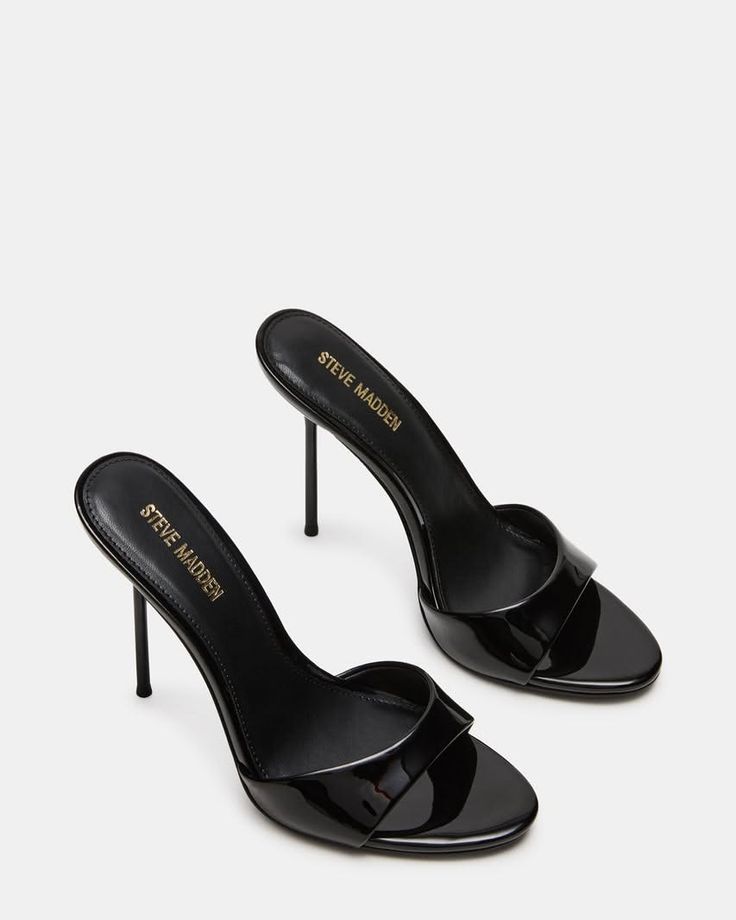 Pair of black patent leather high heels with stiletto heels