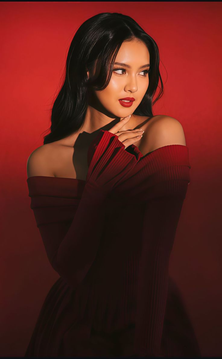 Woman in a red off-shoulder dress with dramatic lighting against a red background