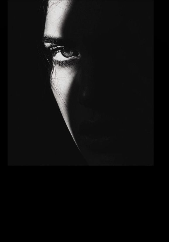 Close up of a person's eye in dramatic black and white lighting