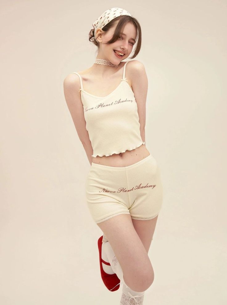 Woman in a ribbed top and shorts with a head scarf and red shoes