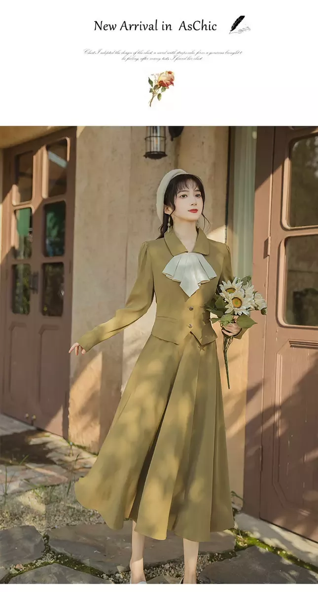 Woman in a long olive dress and beret holding a bouquet of flowers outdoors