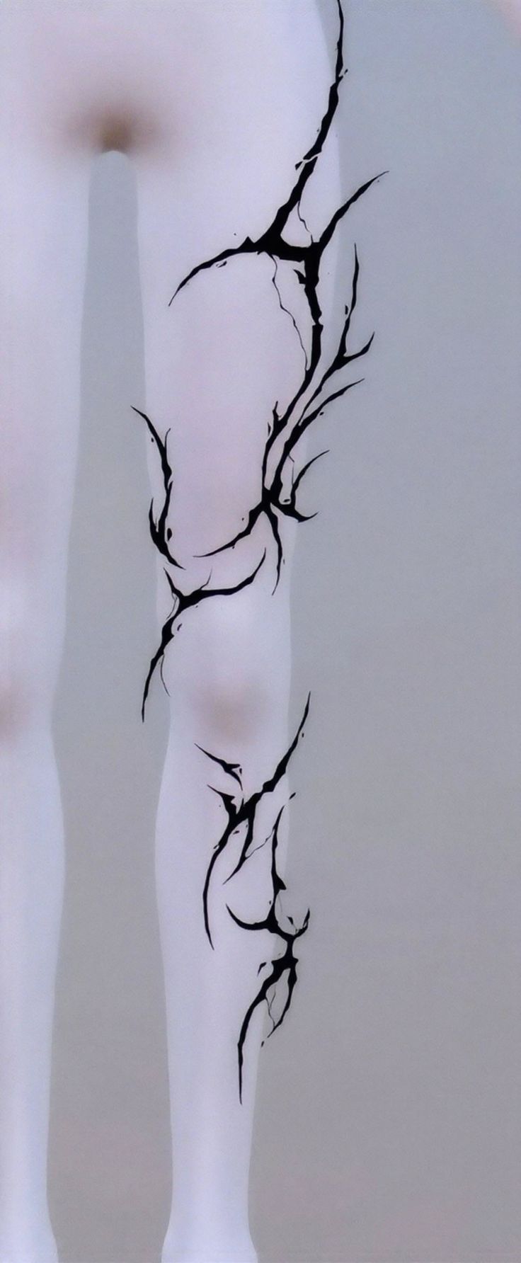 Legs with black abstract tattoos on a light background