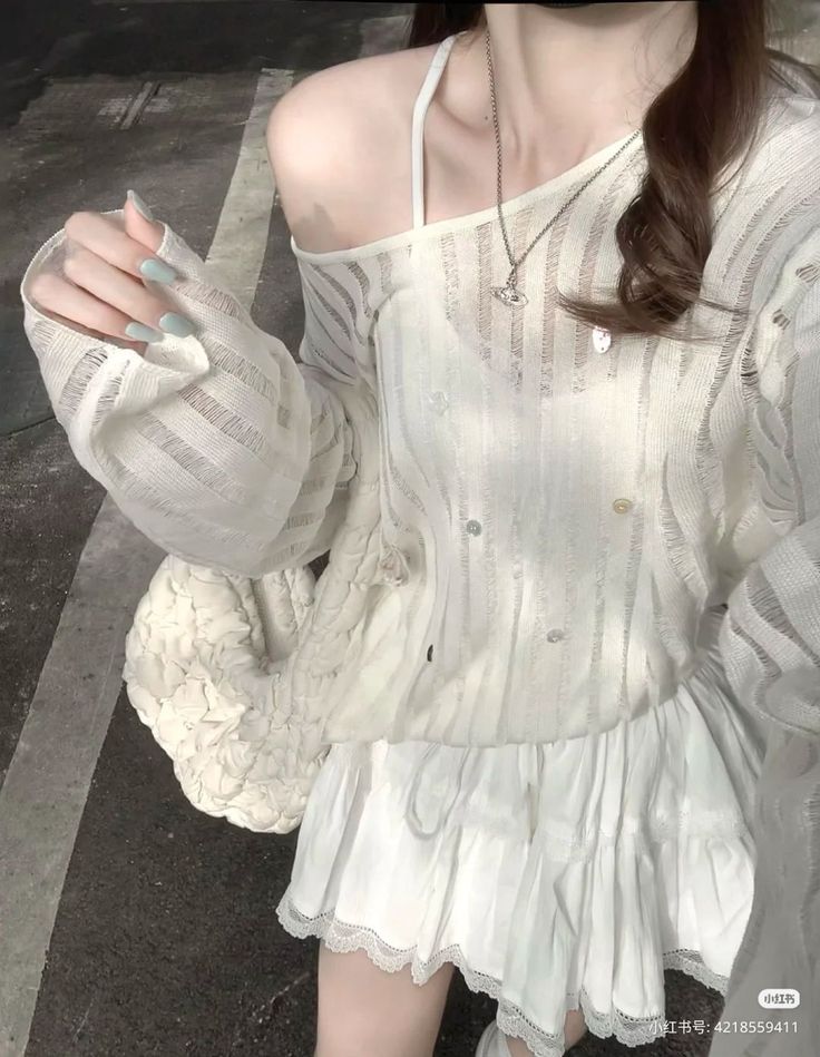 Person in a white off-shoulder top and mini skirt with lace trim