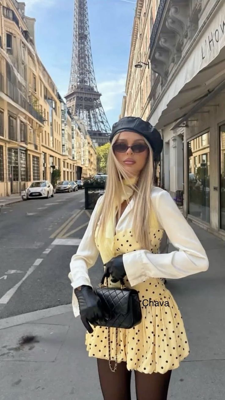 Woman in a polka dot dress and beret on a city street with the Eiffel Tower in the background