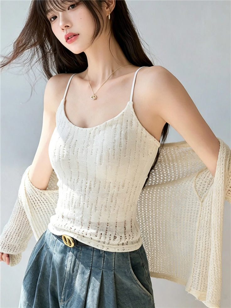 Woman with long hair wearing a white camisole and knitted cardigan