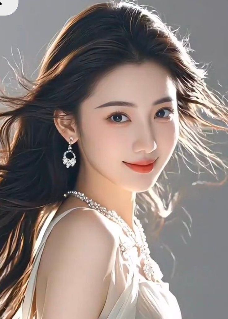 Woman with long hair and jewelry in a portrait with soft lighting