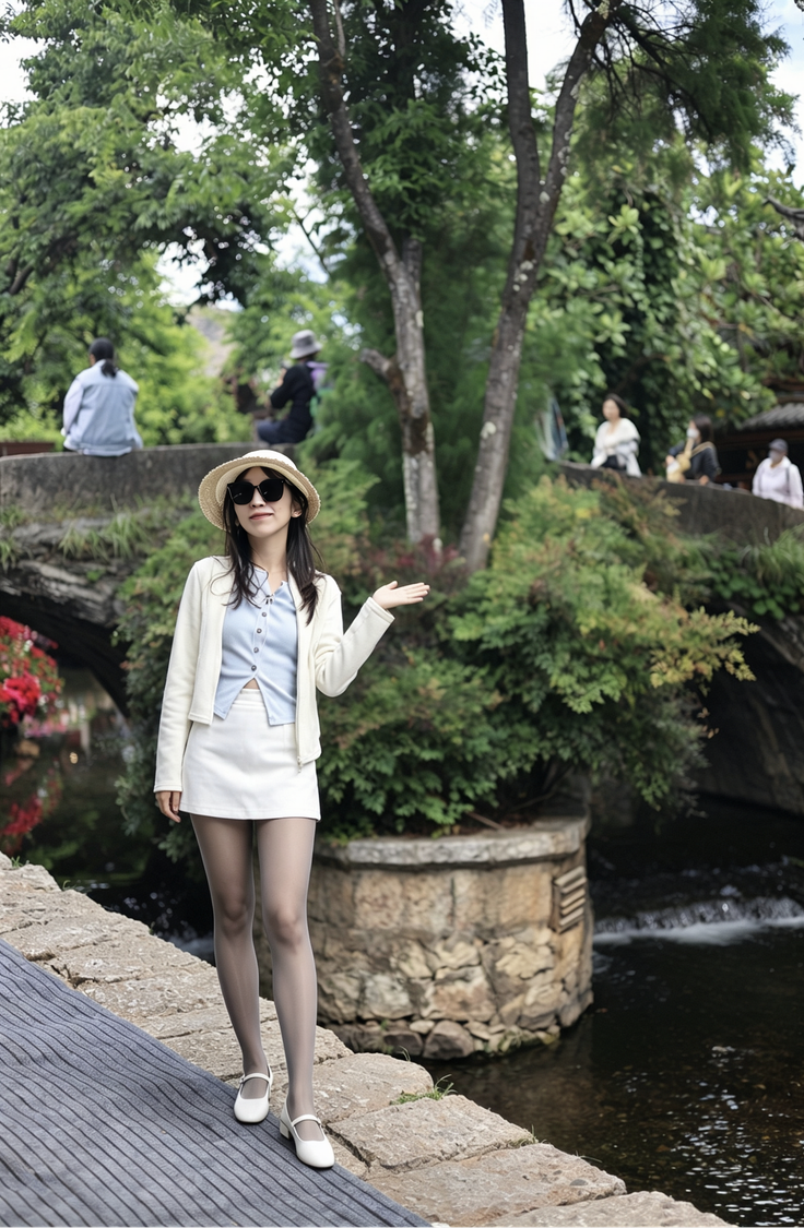 Woman in a straw hat and white skirt posing by a river with green trees