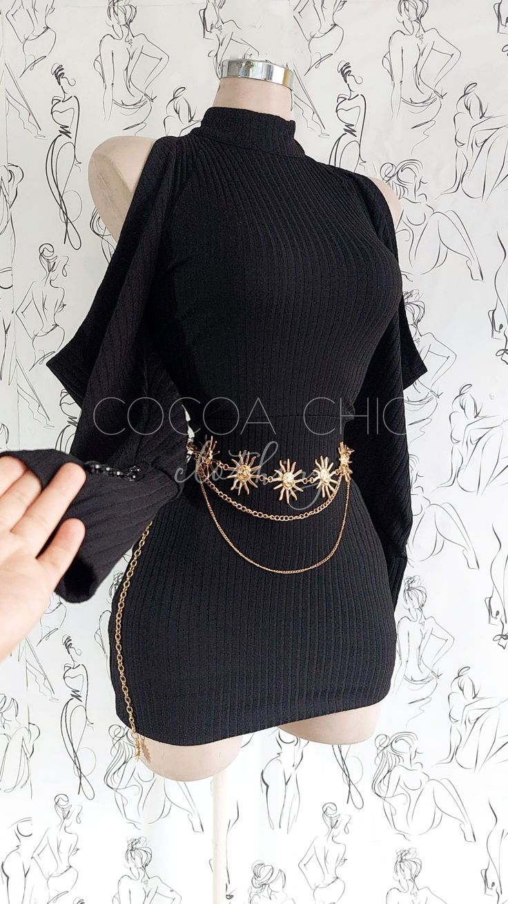 Black ribbed dress with a gold sun-shaped belt on a mannequin