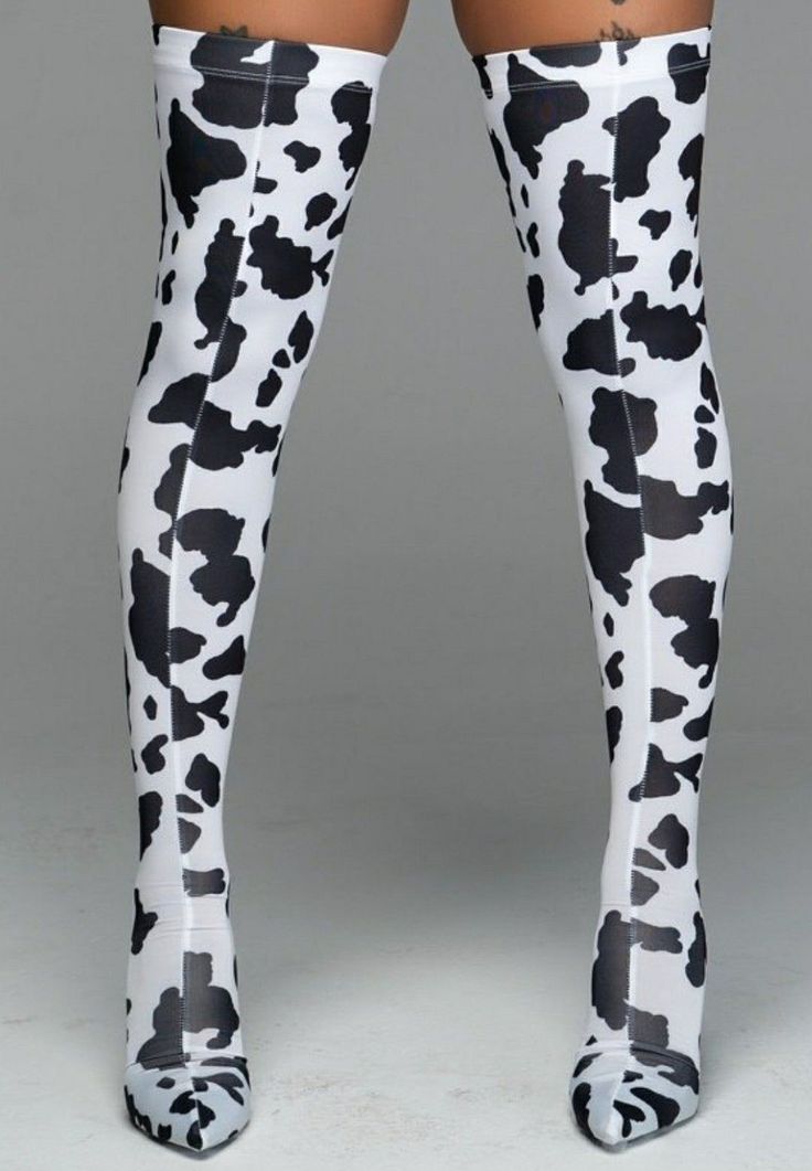Person wearing thigh-high cow print boots with high heels