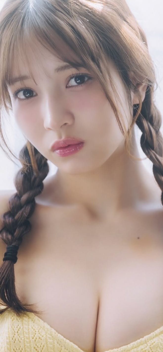 Woman with braids and pink lips, showing cleavage and exposed skin