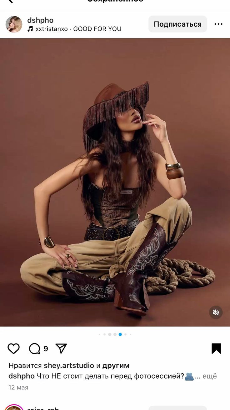 Woman in a cowboy hat and boots sitting on a brown background