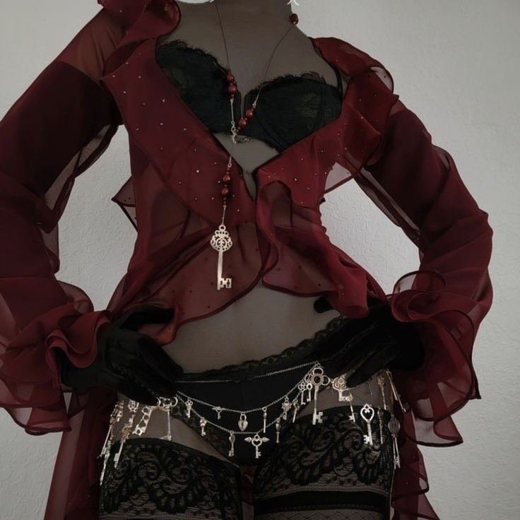 Mannequin in black lingerie with a red sheer top and key chain accessories