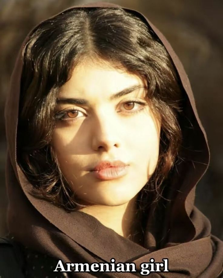Woman with brown hair and eyes wearing a brown headscarf