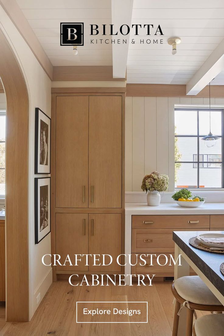 Modern kitchen with wooden cabinets, white countertops, and a large window