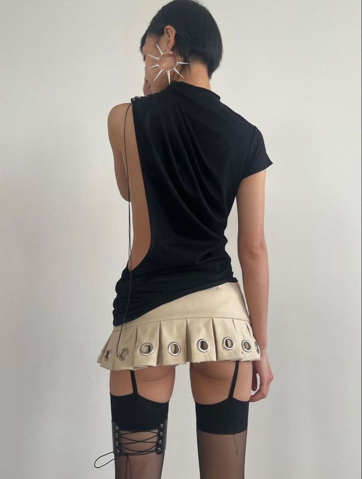 Person in a black top, mini skirt, and thigh high stockings from behind