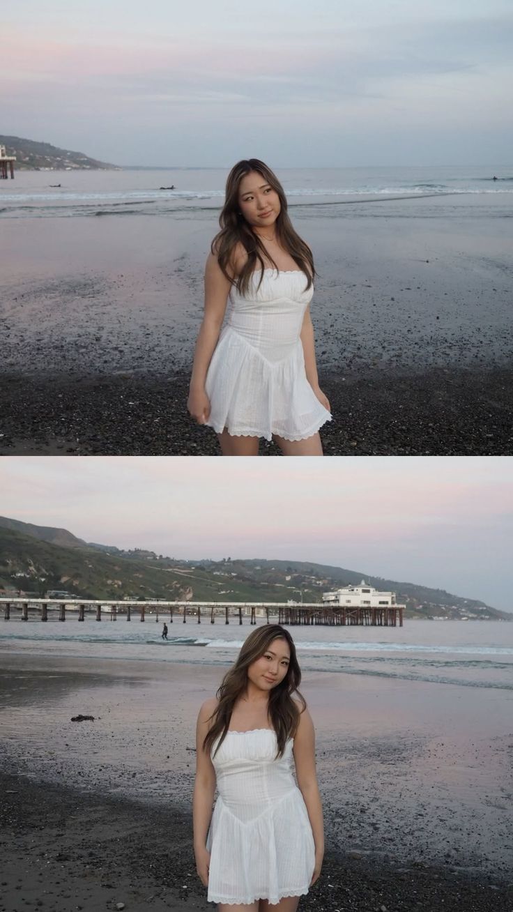 Woman in a white dress standing on a beach with a pier in the background