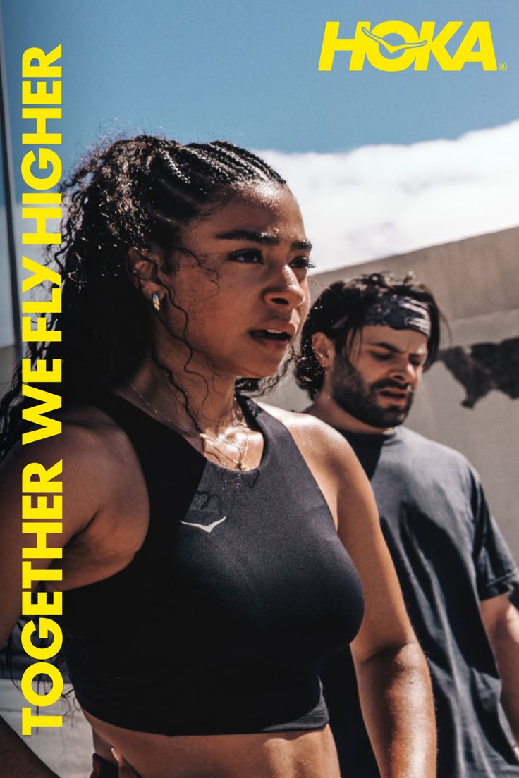 Two athletes, a woman in a sports bra and a man in a t-shirt, outdoors