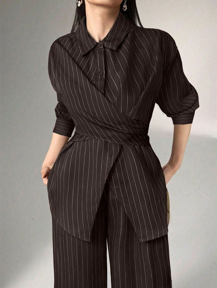 Woman in a dark pinstripe suit with a unique wrap-around top