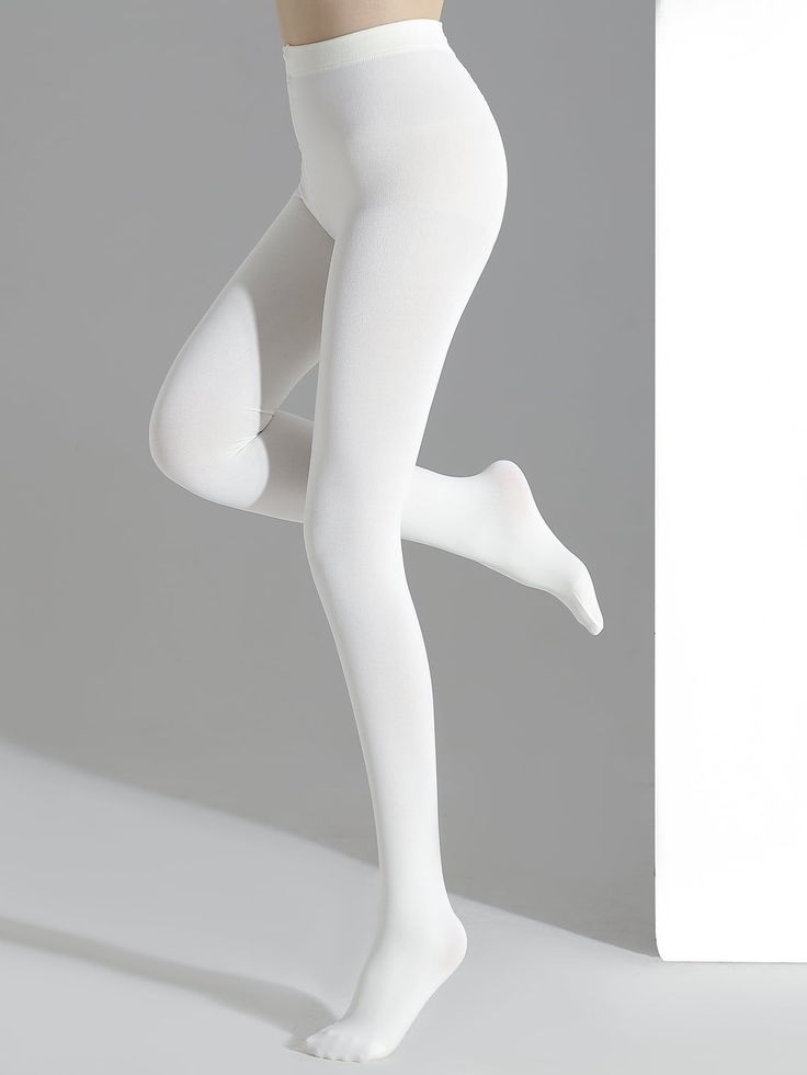 Person wearing white tights in a studio setting