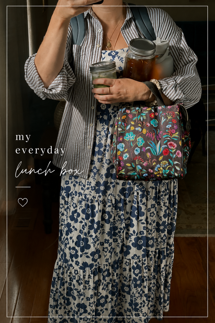 Person holding a floral lunch bag and mason jars, wearing a floral dress and striped shirt