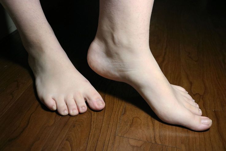 Bare feet on a wooden floor with natural lighting