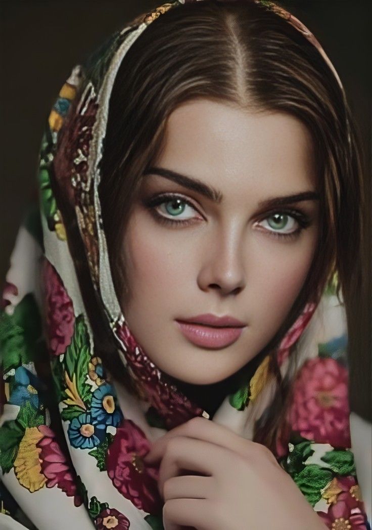 Woman with green eyes wearing a colorful floral headscarf